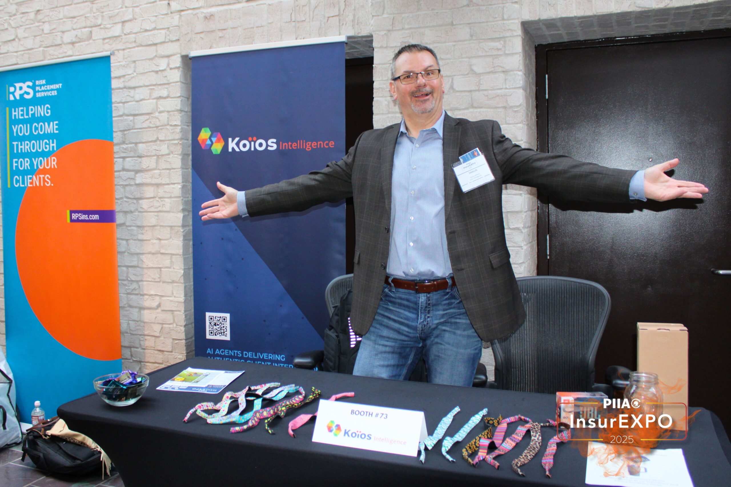 Image from PIIAO of employee at Koios Intelligence booth.